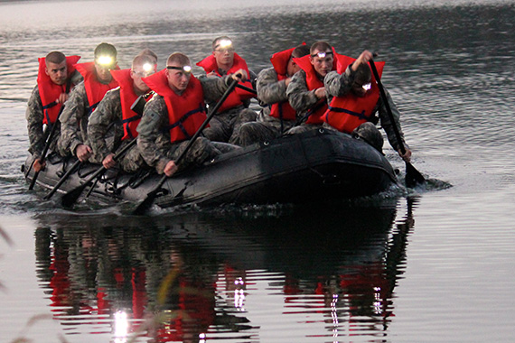 Cadets in raft on water at night
