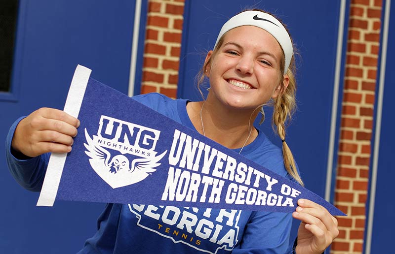 Girl holding UNG pennant