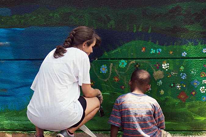 student painting mural