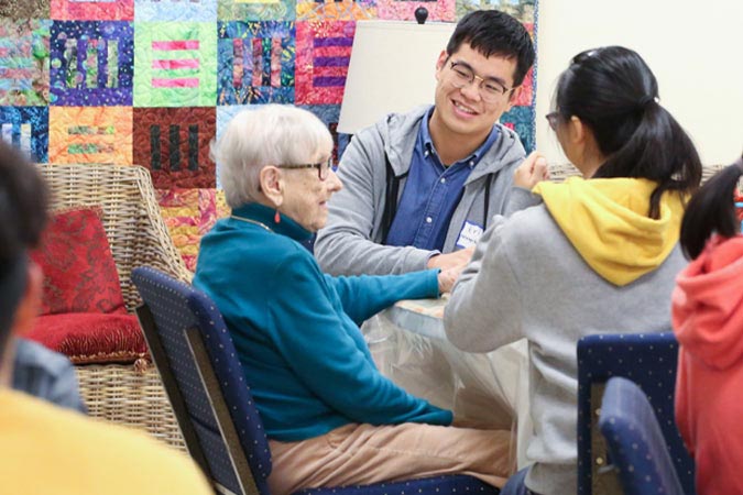 students with elderly person