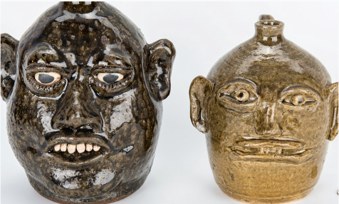 two primative ceramic heads - faces