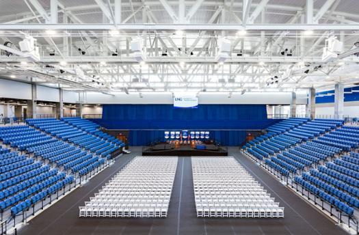 The interior of the Convocation Center is filled with white chairs. Ready for commencement!