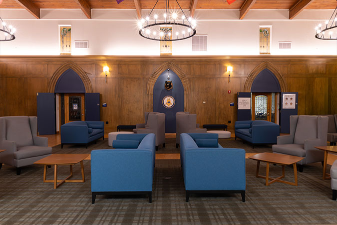 a large room with big comfortable seating that wooden walls 