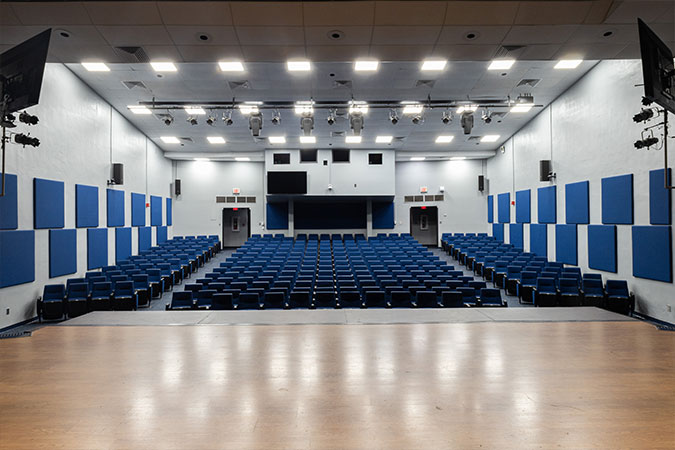 view of the state and seating of an auditorium with sound panels on the wall