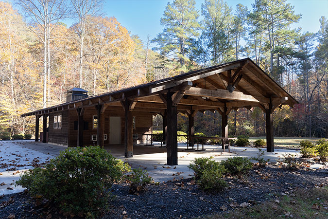 a cabin style event space pavilion within a forested area outside
