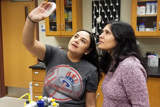 Dr. Swapna Bhat with a student in lab