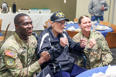 two cadets posing with veteran from merrils marauders