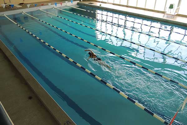 person swimming in Memorial Hall pool
