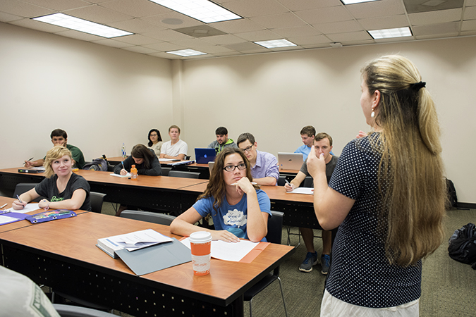 Instructor in front of classroom lecturing to students