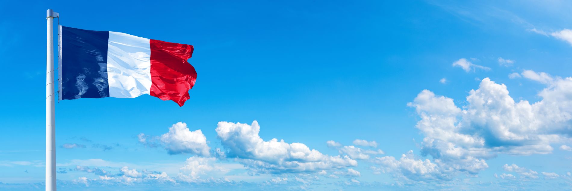 red white blue france flag in blue sky with clouds