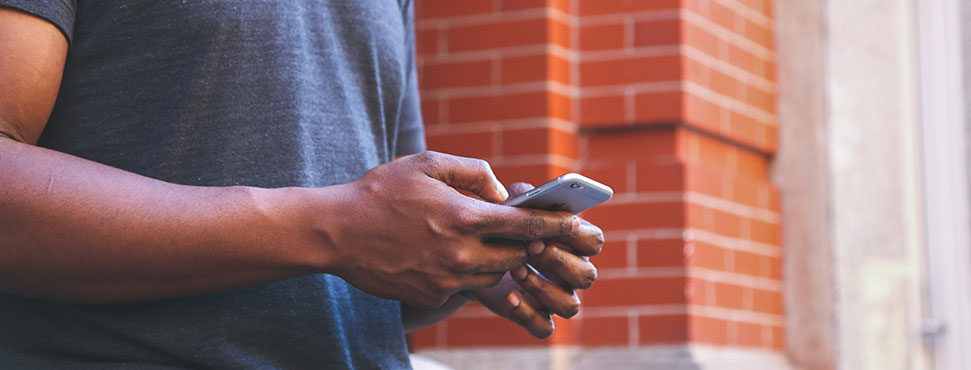 male student using mobile phone to select refund option