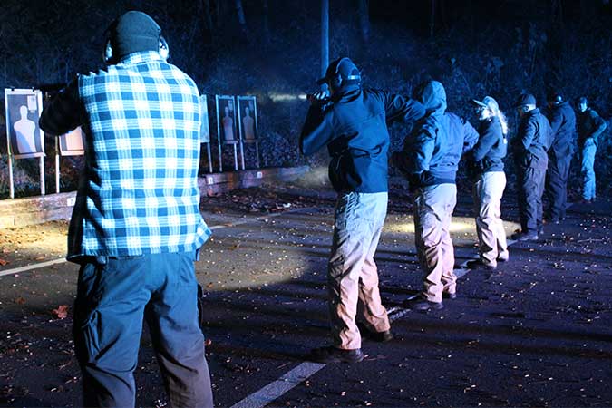 Students firing guns at night