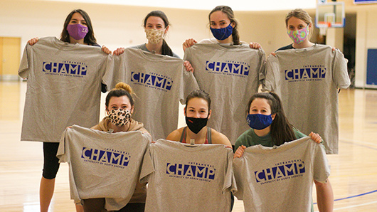 an intramural team poses with their championship shirts