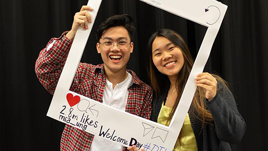 students at a multicultural student affairs event posing for a social media photo