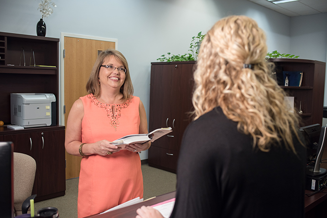 student being assisted in the registrar's office