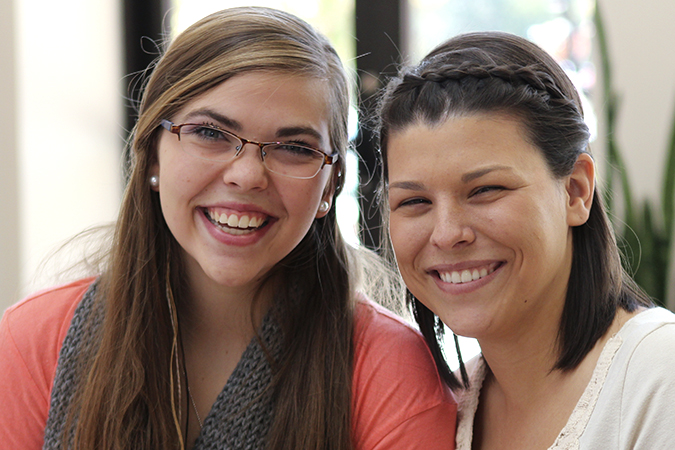 Two female students smiliing