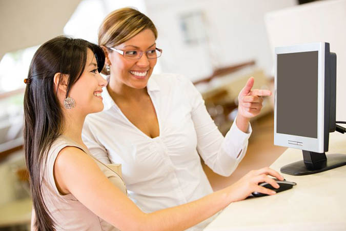 Female student talking to a librarian. Go to Ask a Librarian.