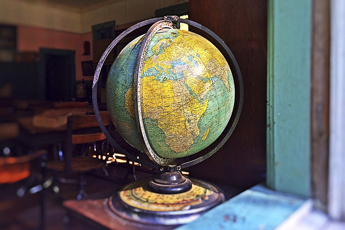 Globe in windowsill of classroom.