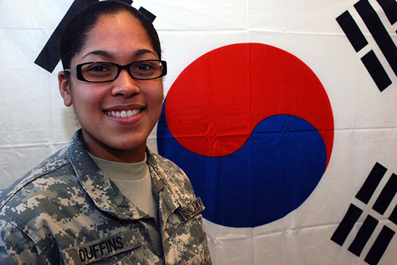 Female Cadet in front of Chinese flag