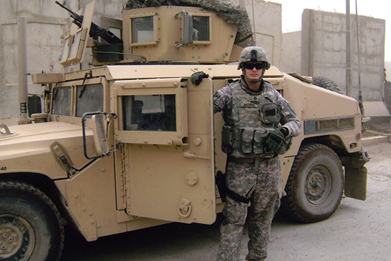 Soldier in front of army vehicle