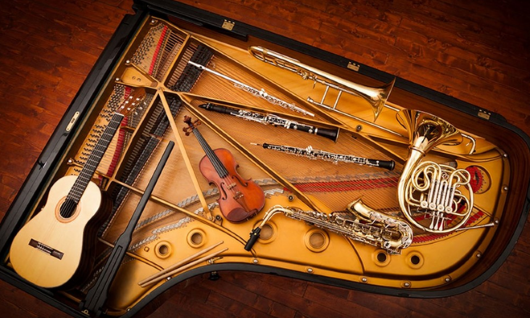 musical instruments arrayed on a piano