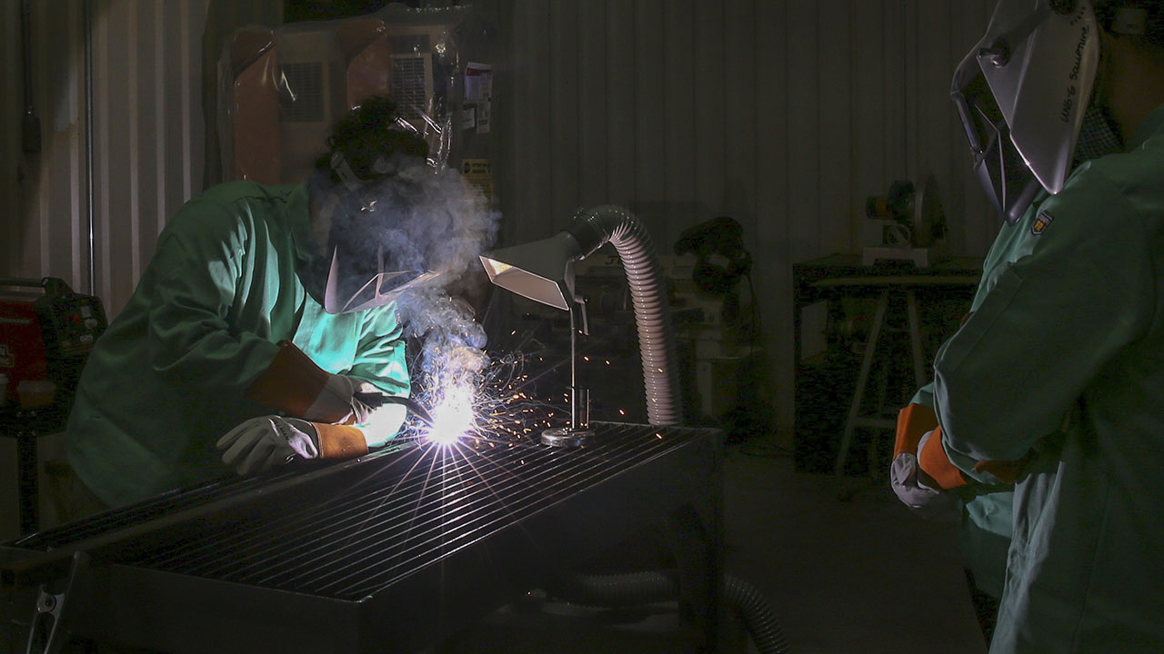Visual arts students learn to weld sculptures for public art