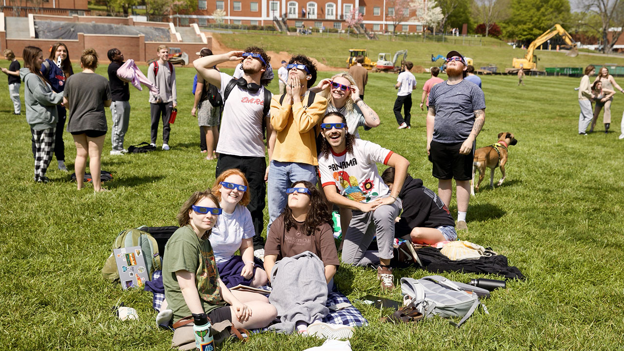 Students help others safely view eclipse