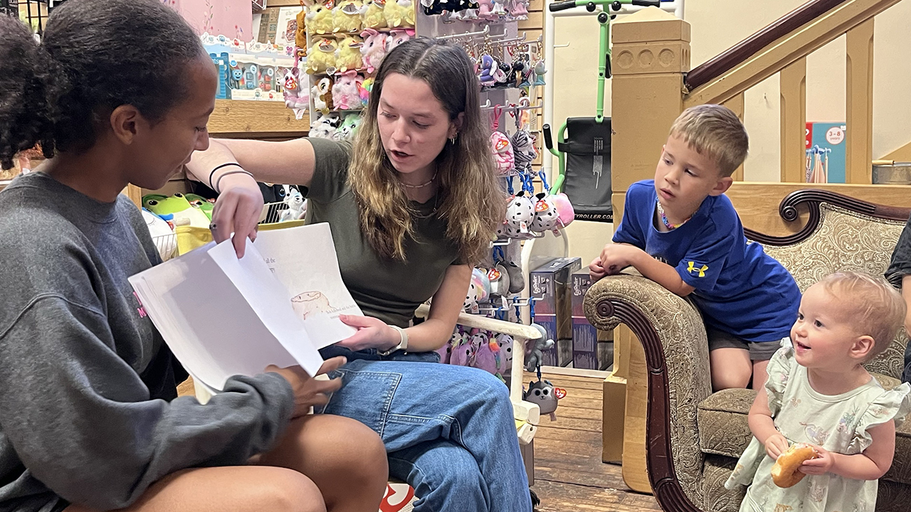 Students Sophia Shaw and Eliza 'Eli' Little read their children's book, 'The Bob and Billy Show,' in a storytime event at Giggle Monkey Toys in Dahlonega, Georgia.