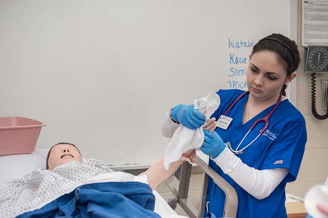 student working with mannequin