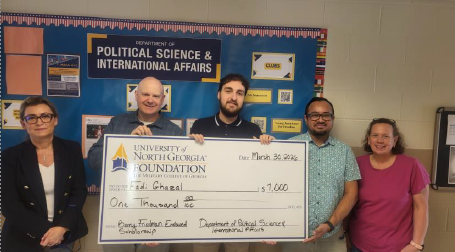 Fadi Ghazal, pictured third, receives the Barry Friedman Scholarship surrounded by PSIA faculty.)