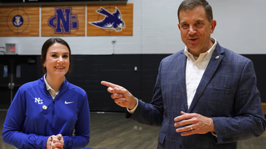 Shannon and Anna Grace Worley talking in the gym