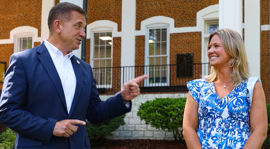 Shannon speaking  with Madison in front of Price Memorial