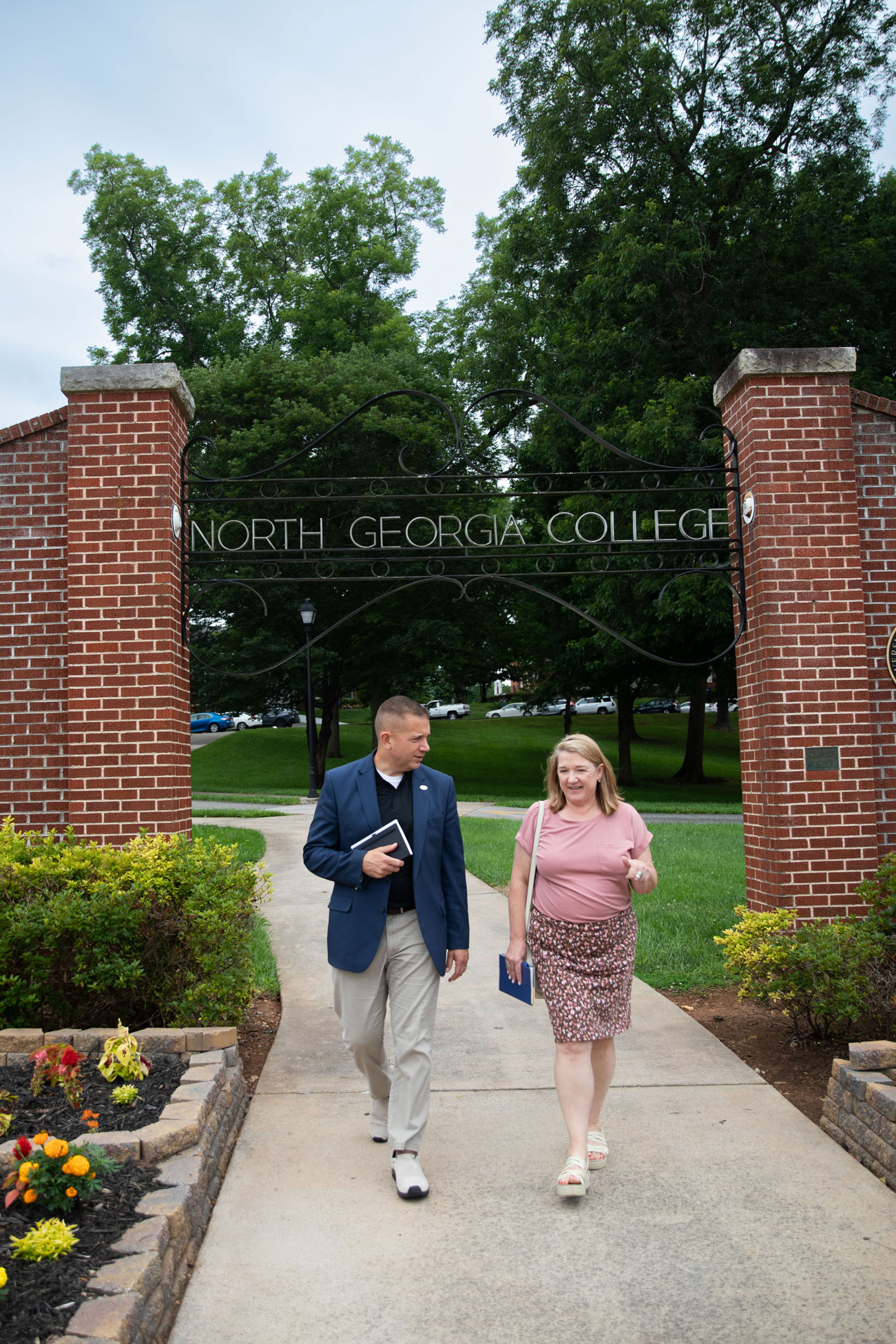 Shannon and the Provost walking under the arch