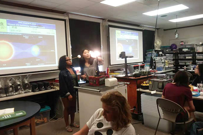 students learning moon phases in class