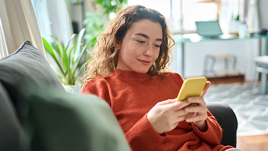 a student on a couch that is ready to talk on the phone