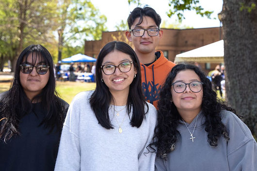 4 students posing outdoors on volunteer day