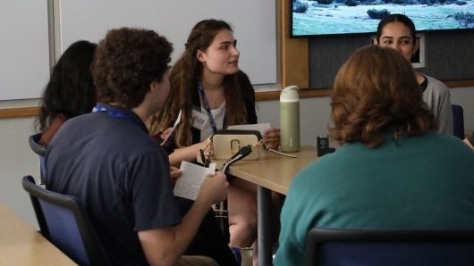 students working at a conference room table