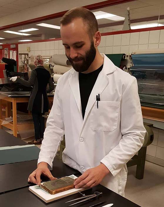 Kyle in a book conservation lab